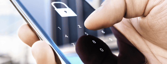 Close up of a person tapping on a phone screen that's locked