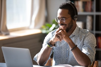 Man smiling at computer_Medium