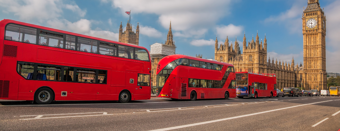Three london buses wait in a queue outside the Houses of Parliment in London