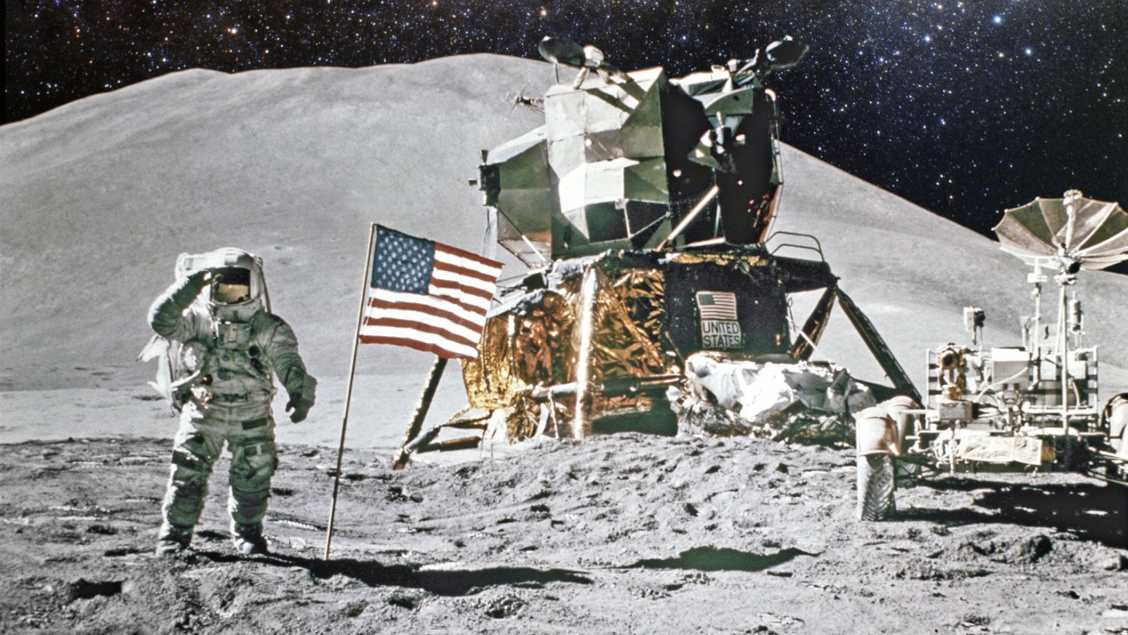 astronaut with US flag sends on the surface of the moon